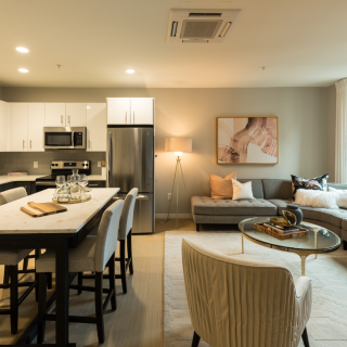 Spacious model kitchen with white cabinets and stainless appliances in Old City apartments