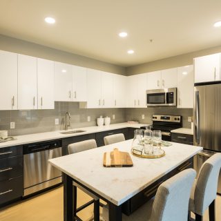 Modern white cabinetry and stainless steel appliances in spacious kitchen of The National apartment rental in Old City