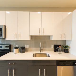 Fantastic kitchen with stainless steel appliances and bright white cabinets in Old City apartment rental homes