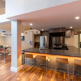 Communal kitchen in The National two-story resident clubhouse with spacious seating options in Old City apartments